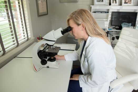 Dr. Jennifer Smith using a Microscope